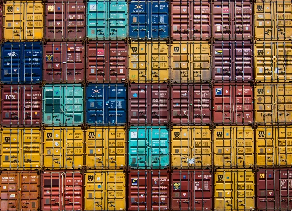 Wall of stacked shipping containers in many colours