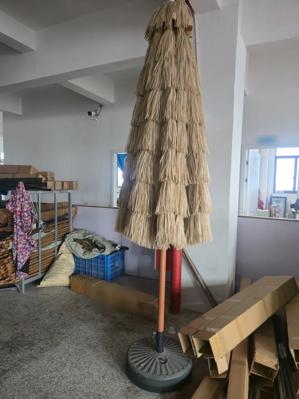 A thatch-style tiki umbrella sample on a round base
