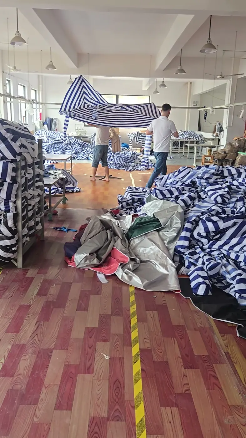 A striped canopy being test-fitted in the sewing workshop