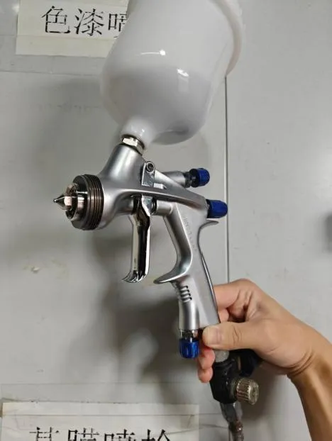 A spray gun held in a hand